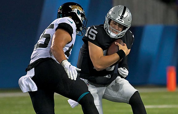 Jacksonville Jaguars linebacker Grant Morgan (55) sacks Las Vegas Raiders quarterback Chase Garbers (15) during the second half at Tom Benson Hall of Fame Stadium.